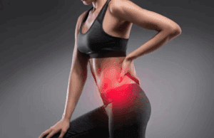 Woman experiencing lower back pain from sciatica, highlighting muscle tension before sports massage and Winback Tecar therapy treatment in Windsor clinic.