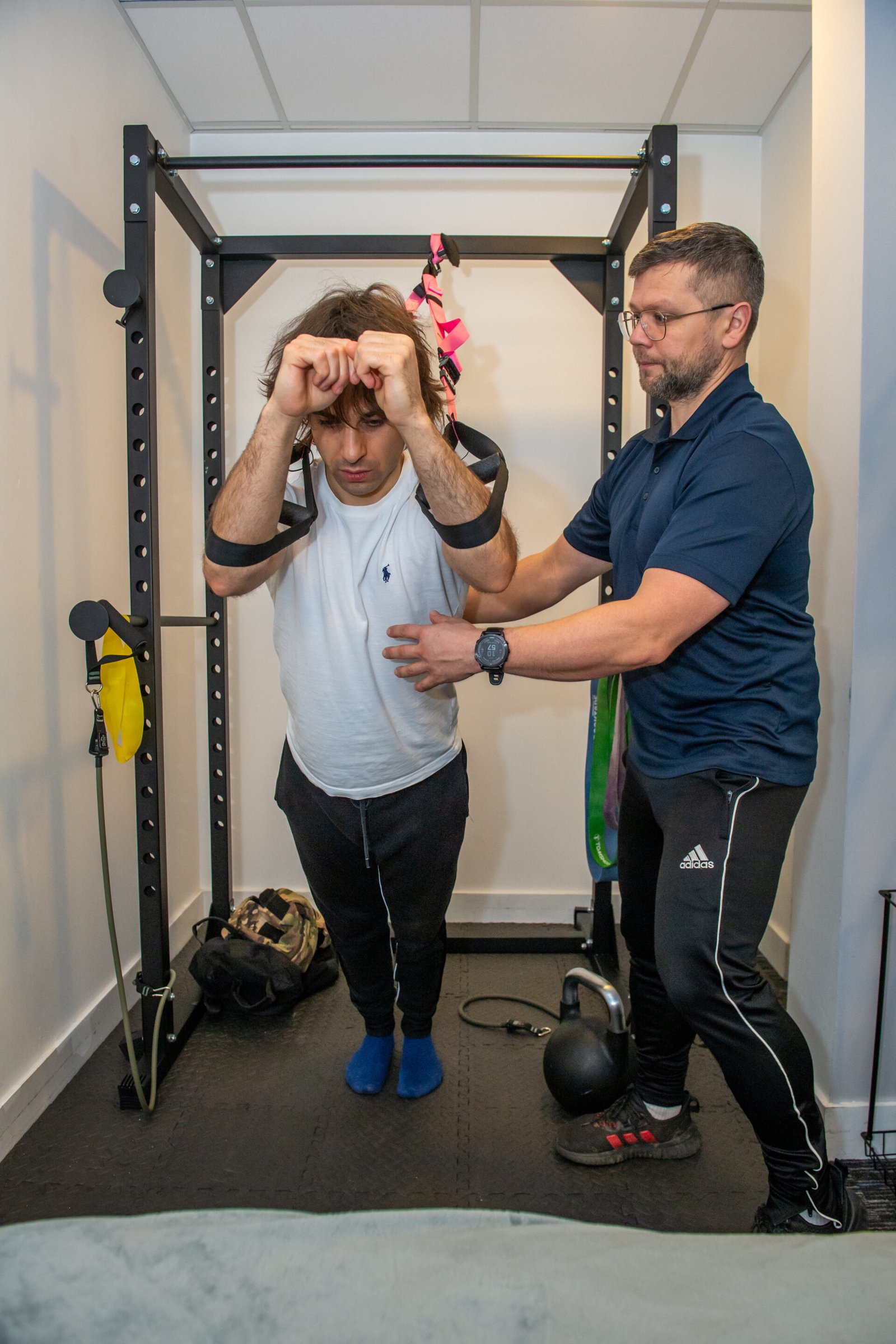 Personal trainer coaching movement technique during a strength training session